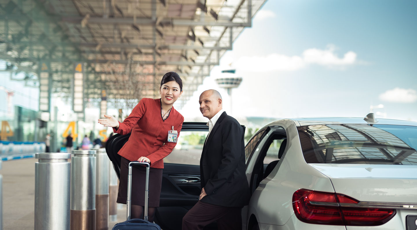 Customer service officer sending passenger off at taxi stand