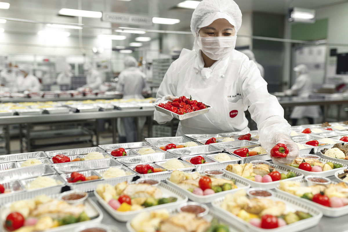 Chef putting red pepper into lunchbox