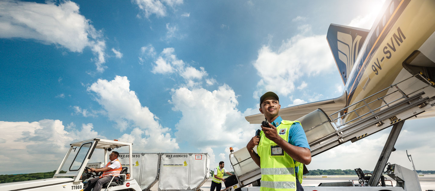 SATS staff at apron with SIA plane