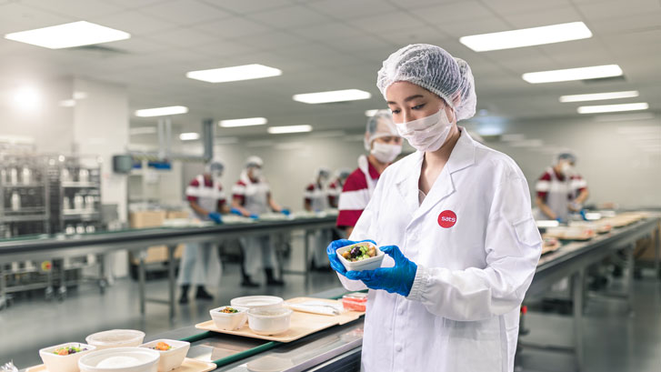 Nutritionist inspecting food at Sengkang Hospital